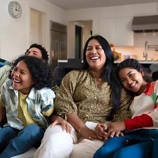 family laughing on couch