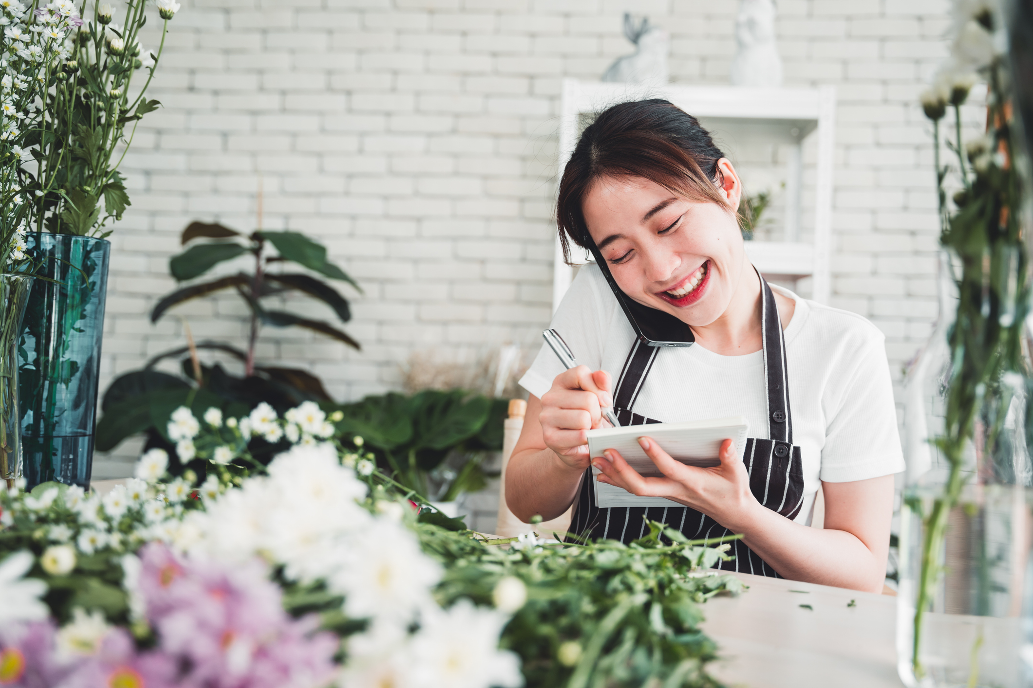 Florist taking orders on cell phone